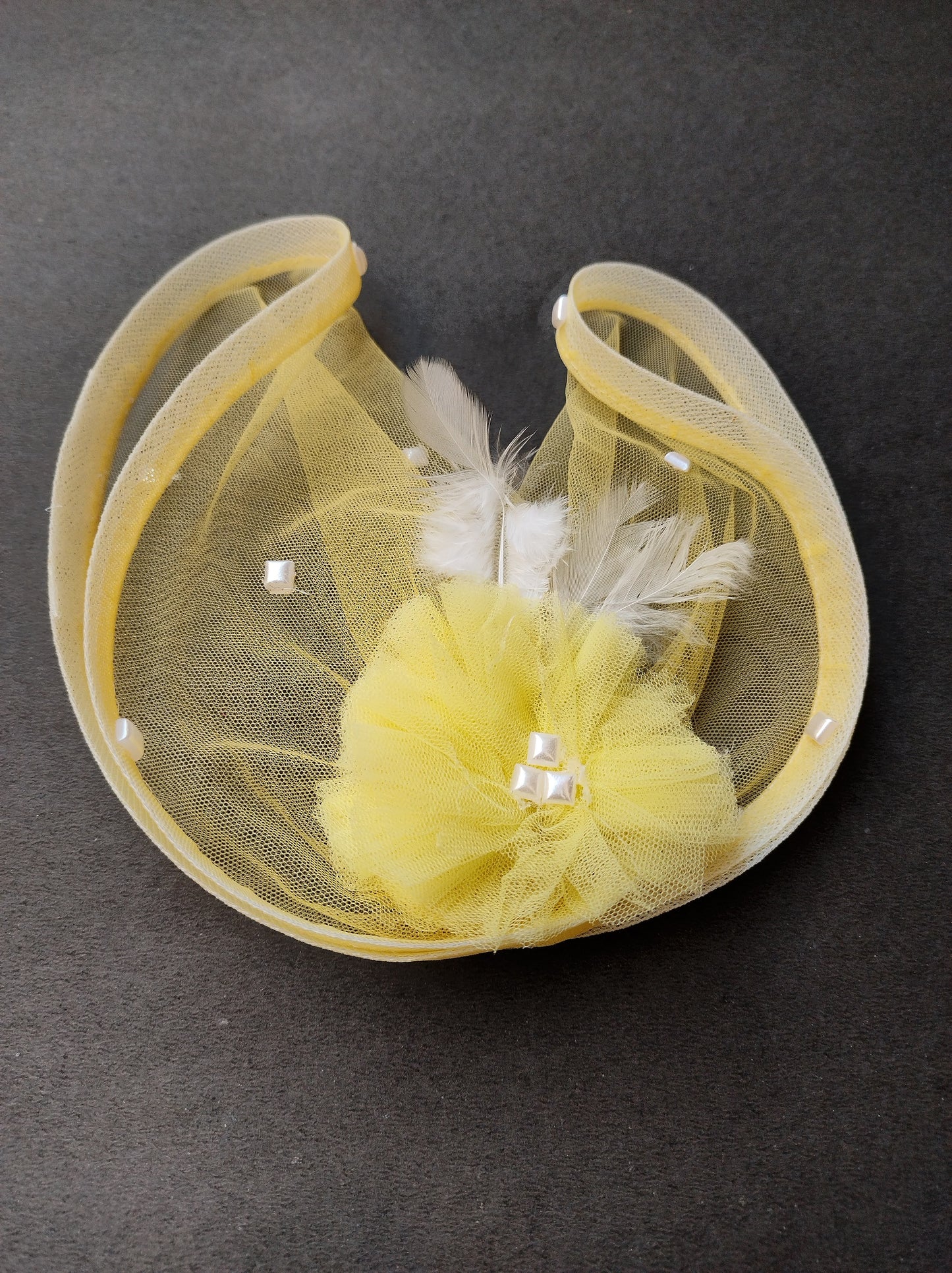 Yellow feather fascinator